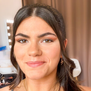 Invitée de mariage souriante avec un maquillage naturel et lumineux réalisé par Leawakeup à Roanne.